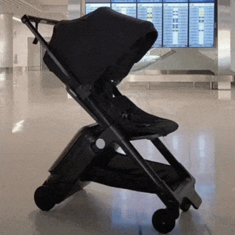 Dad at airport folding up TernX Carry On Suitcase Stroller